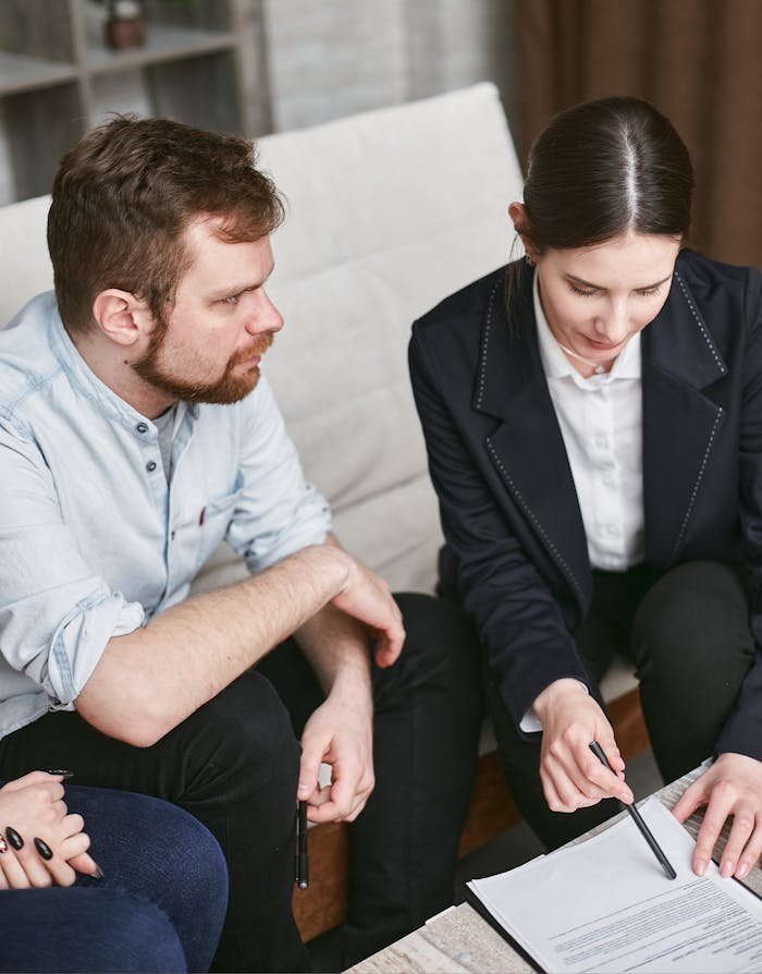 Business professionals in a meeting reviewing significant documents in an office setting.